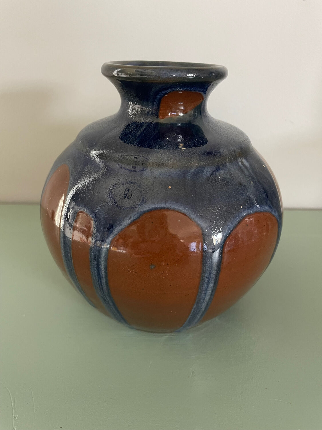 Old blue and brown vase with drips.
