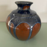 Old blue and brown vase with drips.