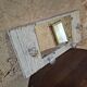 Wall-mounted coat rack with a patinated mirror