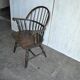 Brown wooden Windsor chair, 19th century — slatted backrest and carved seat