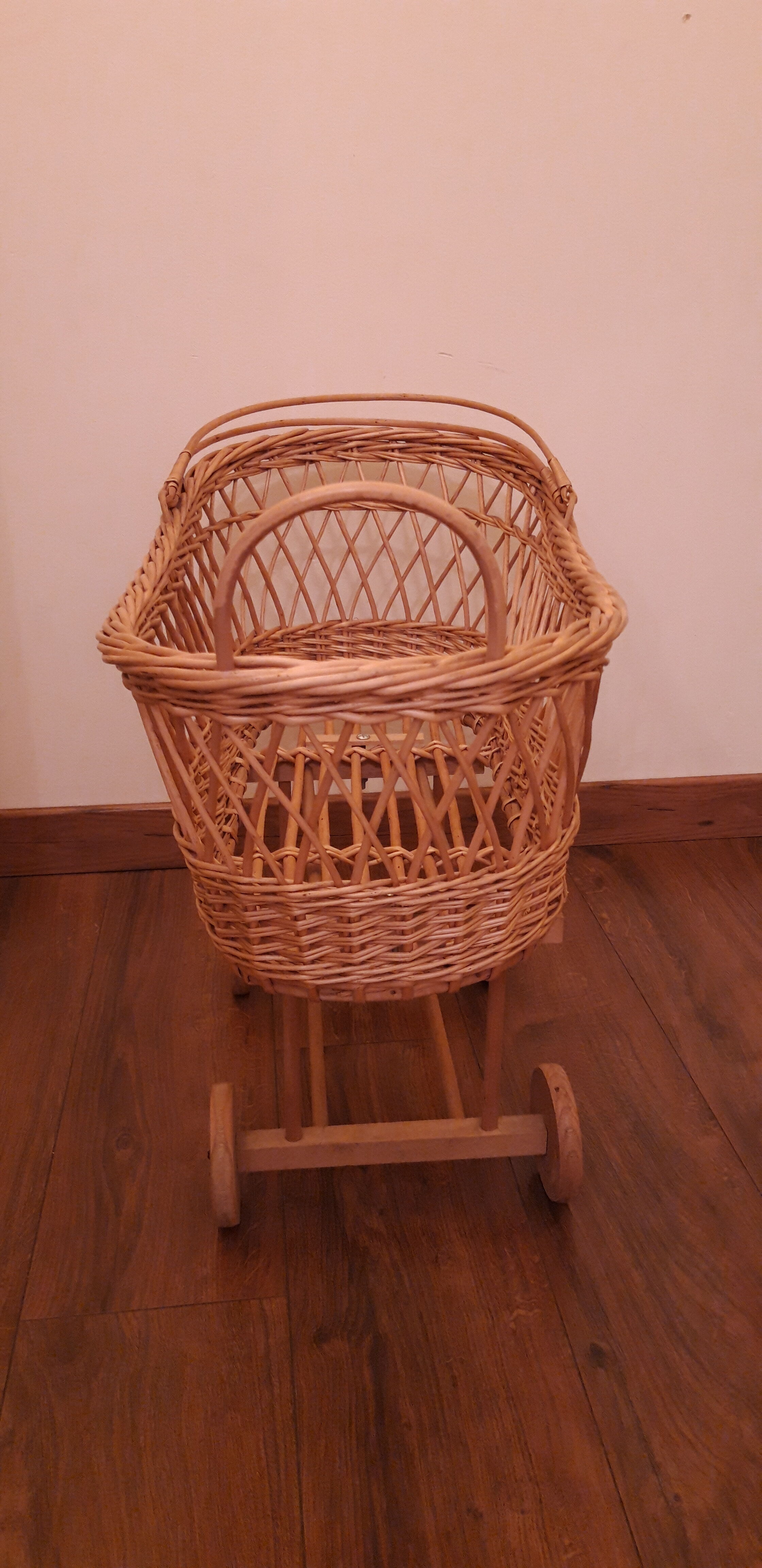 Vintage wicker cradle with wheels