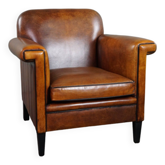 Sheepskin Art Deco design armchair with accents all around