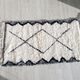 Berber carpet Béni Ouarain black and white with diamonds and braided border
