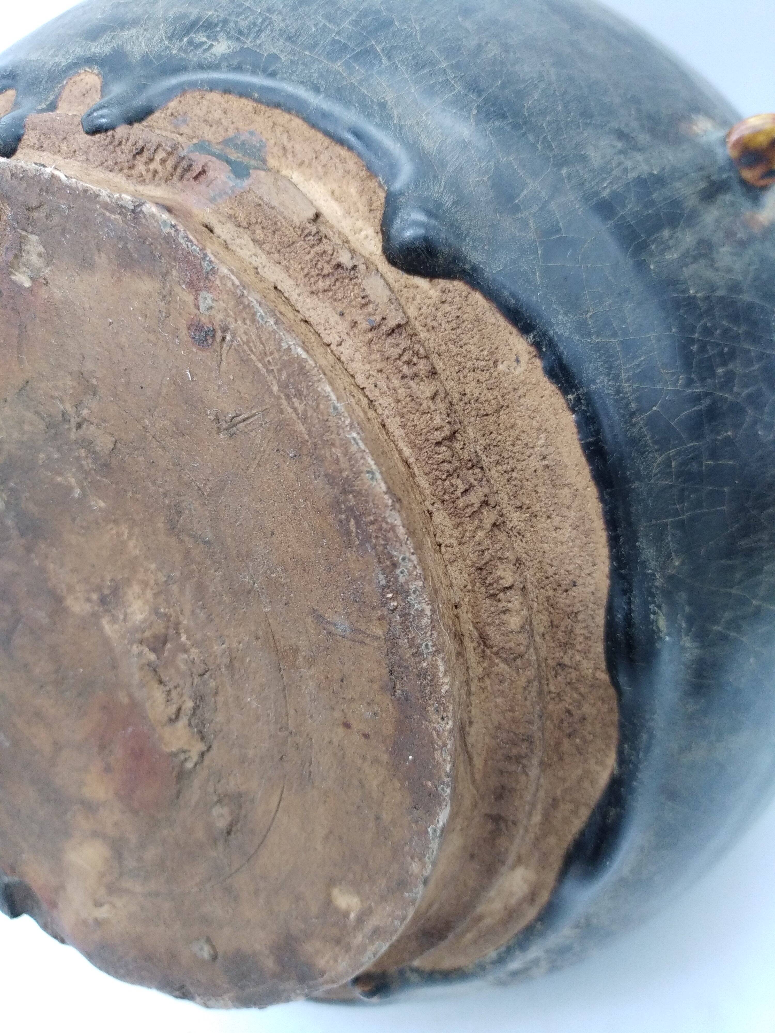 Antique Khmer ceramic vase. With elephant decoration.