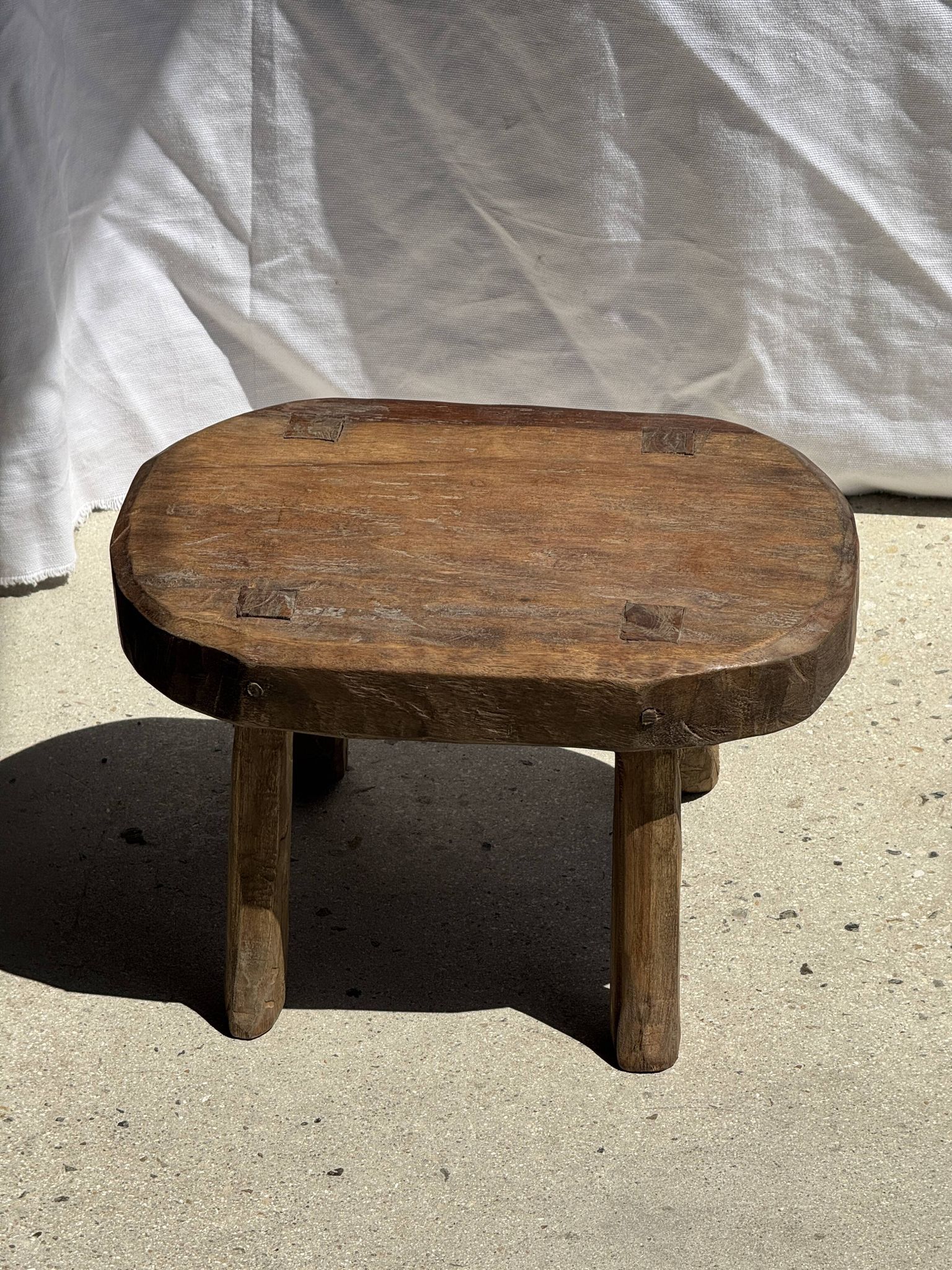 Small stool, oval solid teak accent stool with a two-tone seat.