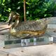 Vintage brass table lamp in the shape of a duck from the 1970s on an acrylic base.