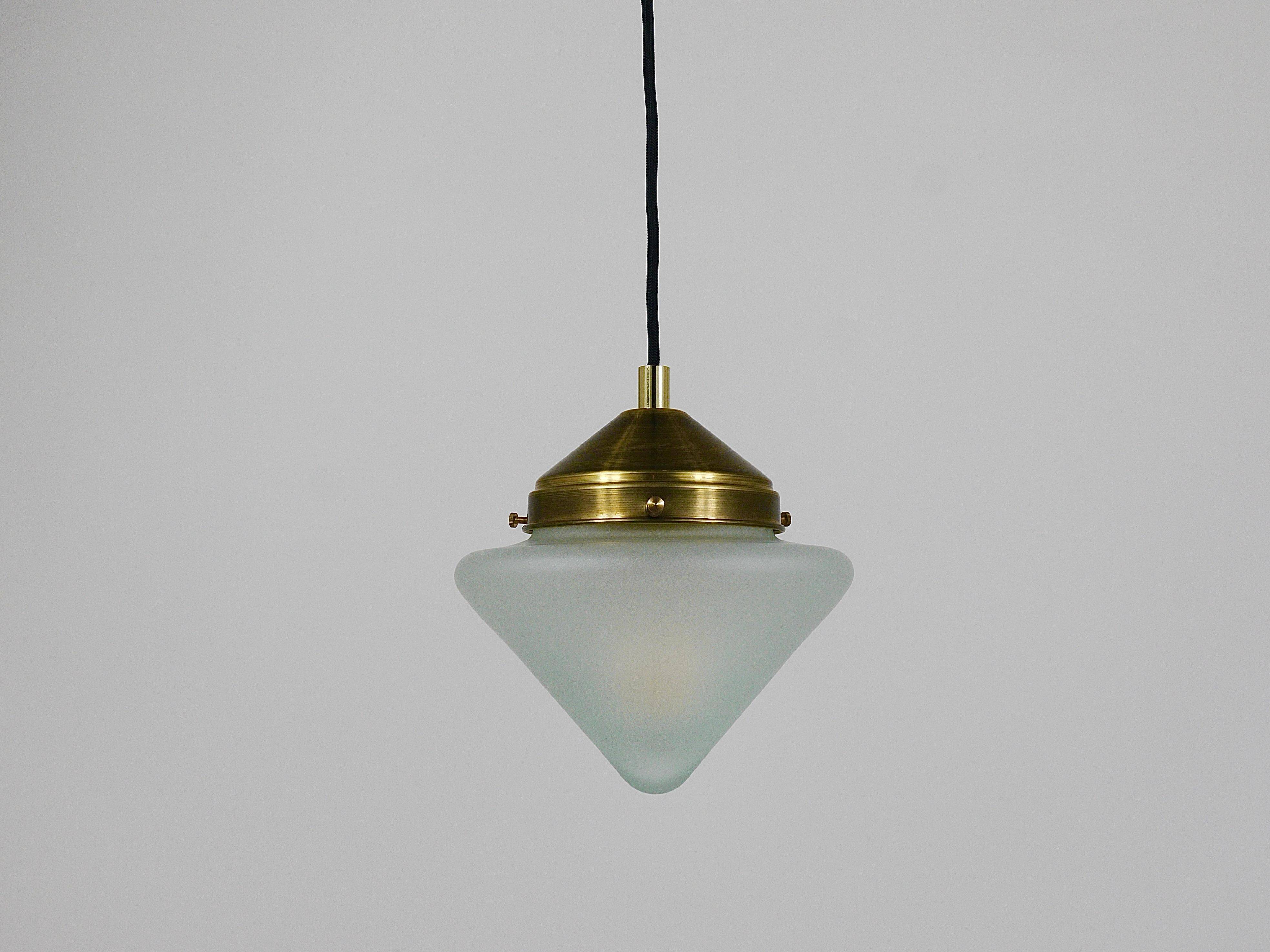 Up to 7 Art Deco brass pendant lights with conical glass shades, Vienna 1930s.