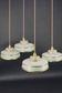 Set of 4 Art Deco pendant lights in frosted water green and gold.