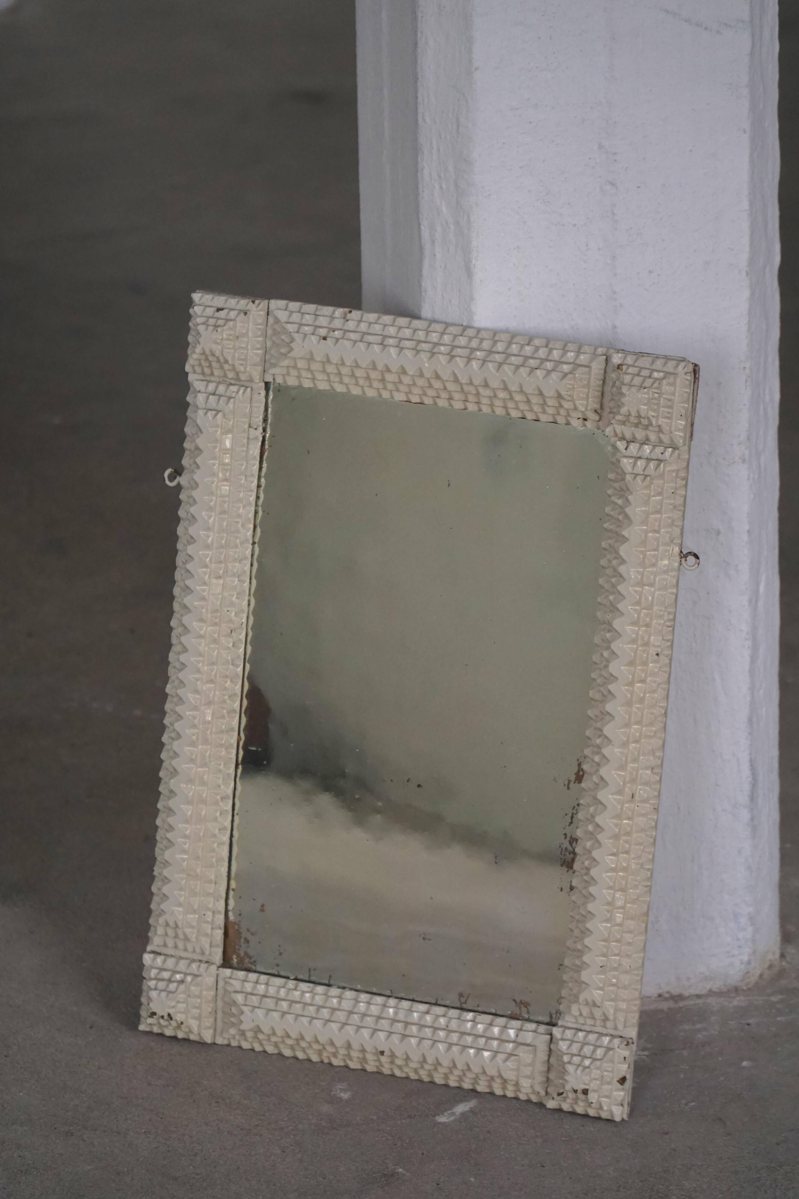 Wall mirror in tramp art style, hand-carved with a painted white frame, early 1900s.