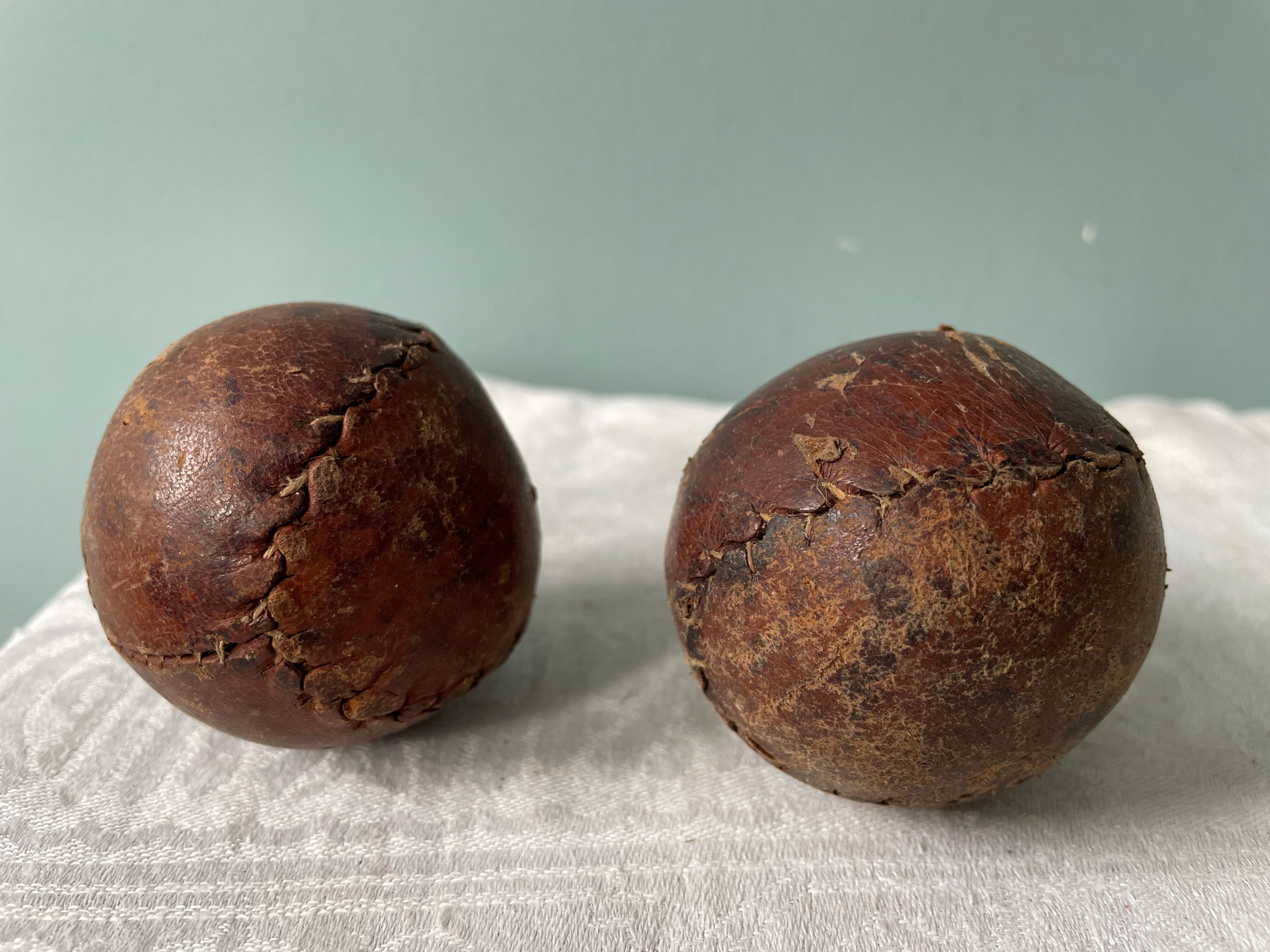 Two old nineteenth century leather golf balls