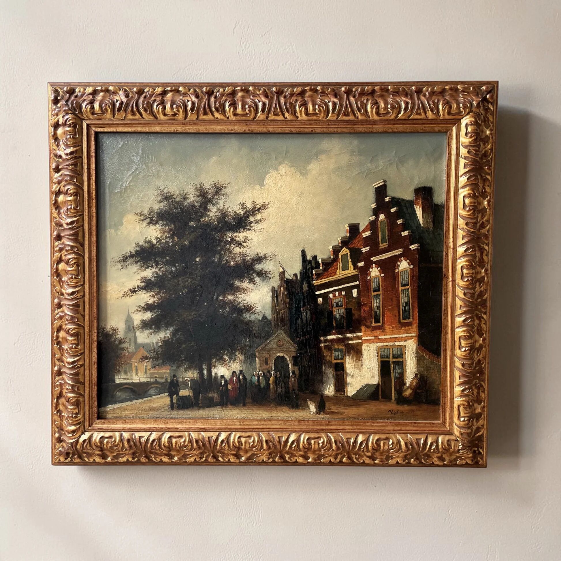 Dutch street scene oil painting in ornate frame signed Nijland