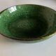 Shallow dish Aegitna on a green glazed earthenware base