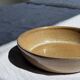 A solid brown flat-bottomed stoneware bowl D18