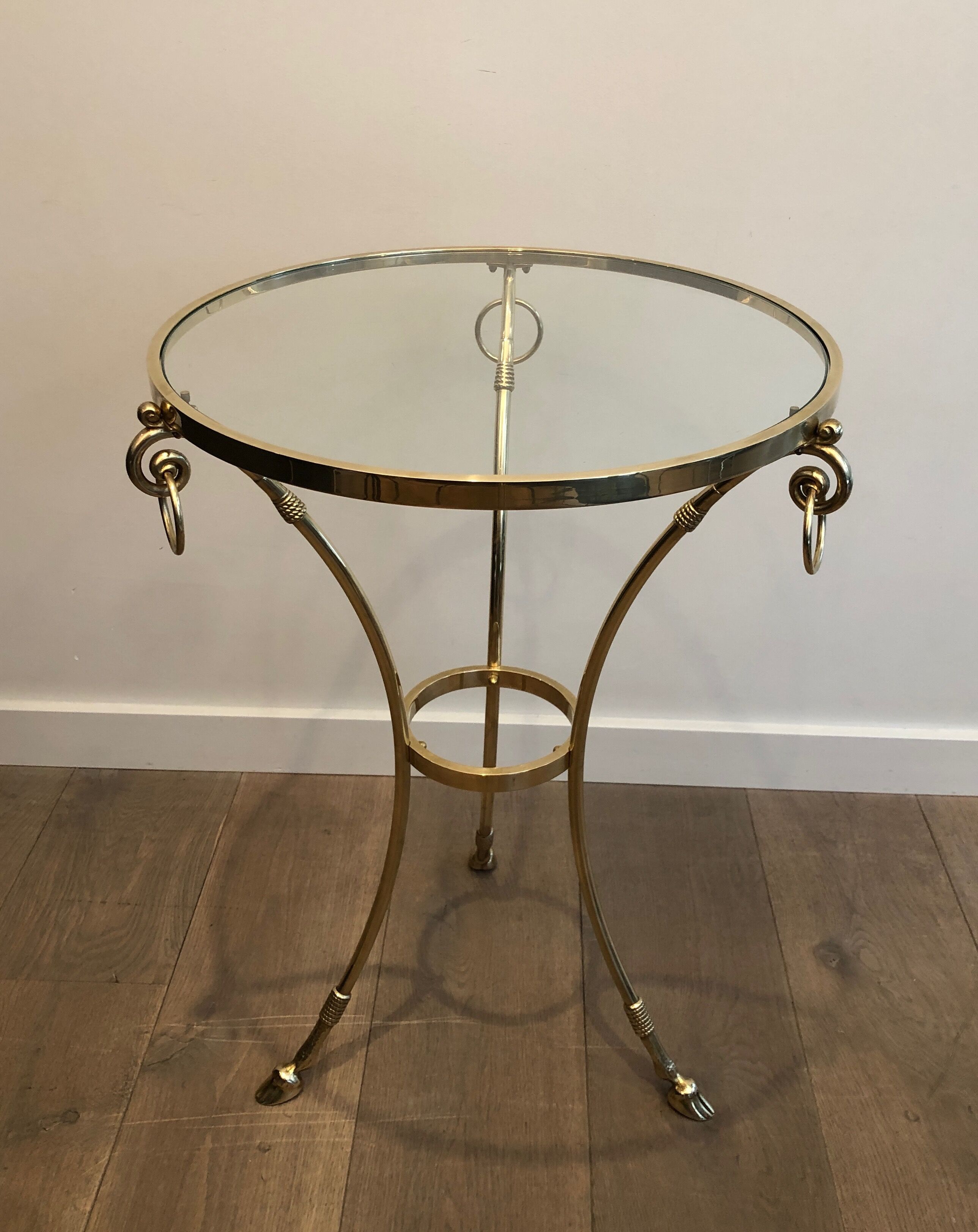 Neoclassical style tripod pedestal table in brass and round glass top in the taste of the House