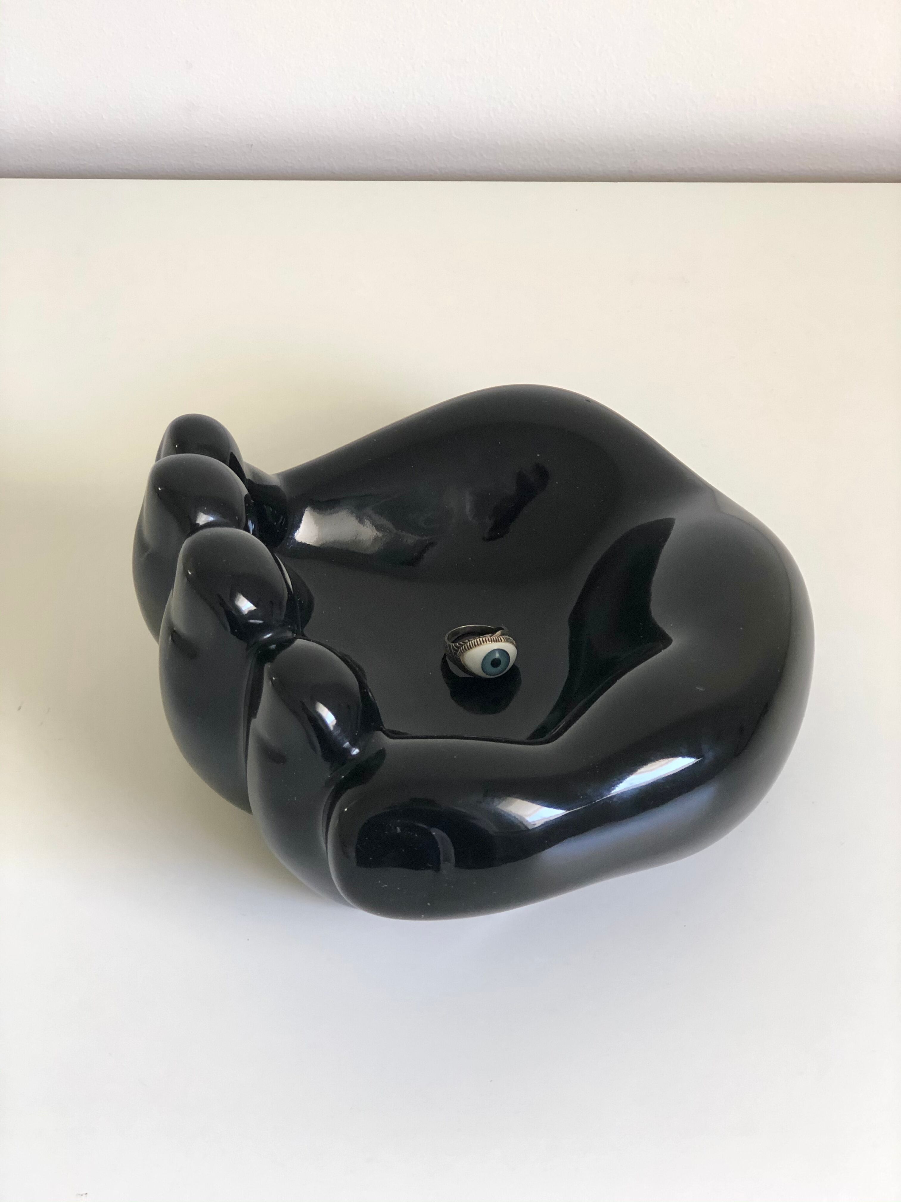 Empty black enamelled hand-shaped ceramic pocket, 1970