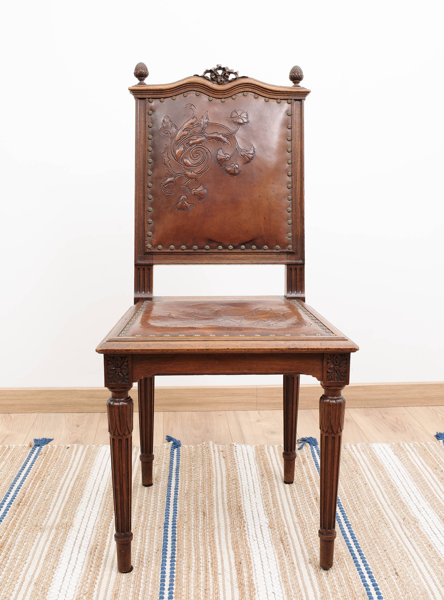 Set of 4 Louis XVI style chairs in carved wood and embossed leather.