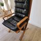 Scandinavian armchair in wood and leather.