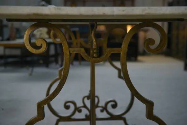 Side table with a gilt wrought iron base attributed to Gilbert Poillerat, with a travertine top, 1940s