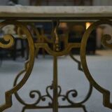 Side table with a gilt wrought iron base attributed to Gilbert Poillerat, with a travertine top, 1940s