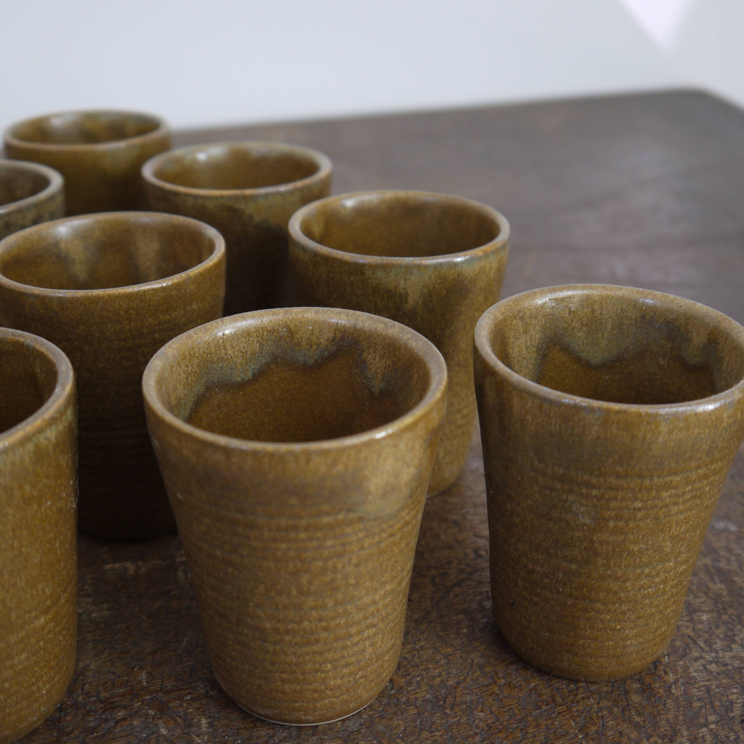 Lot of ten cups of Digoin sandstone