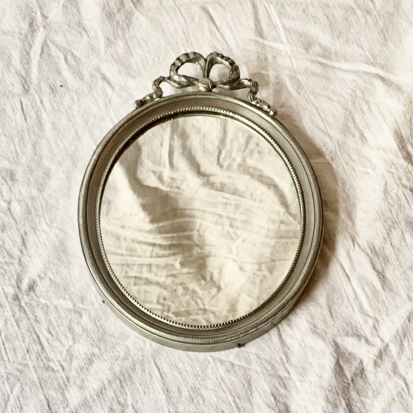 Louis XVI style oval metal wall mirror