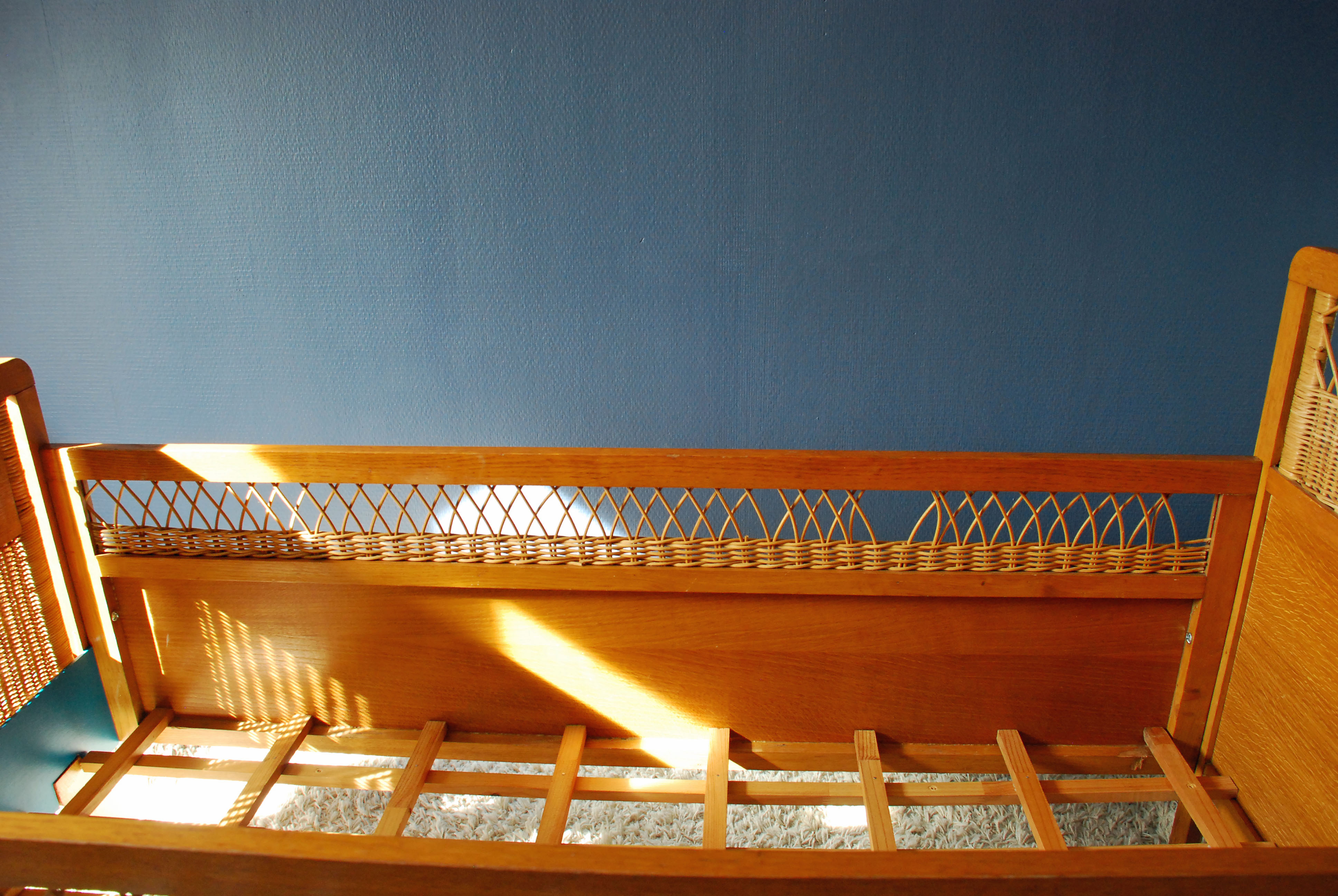 Wooden bed and vintage rattan
