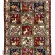 Handmade Persian carpet, featuring animal and plant motifs.