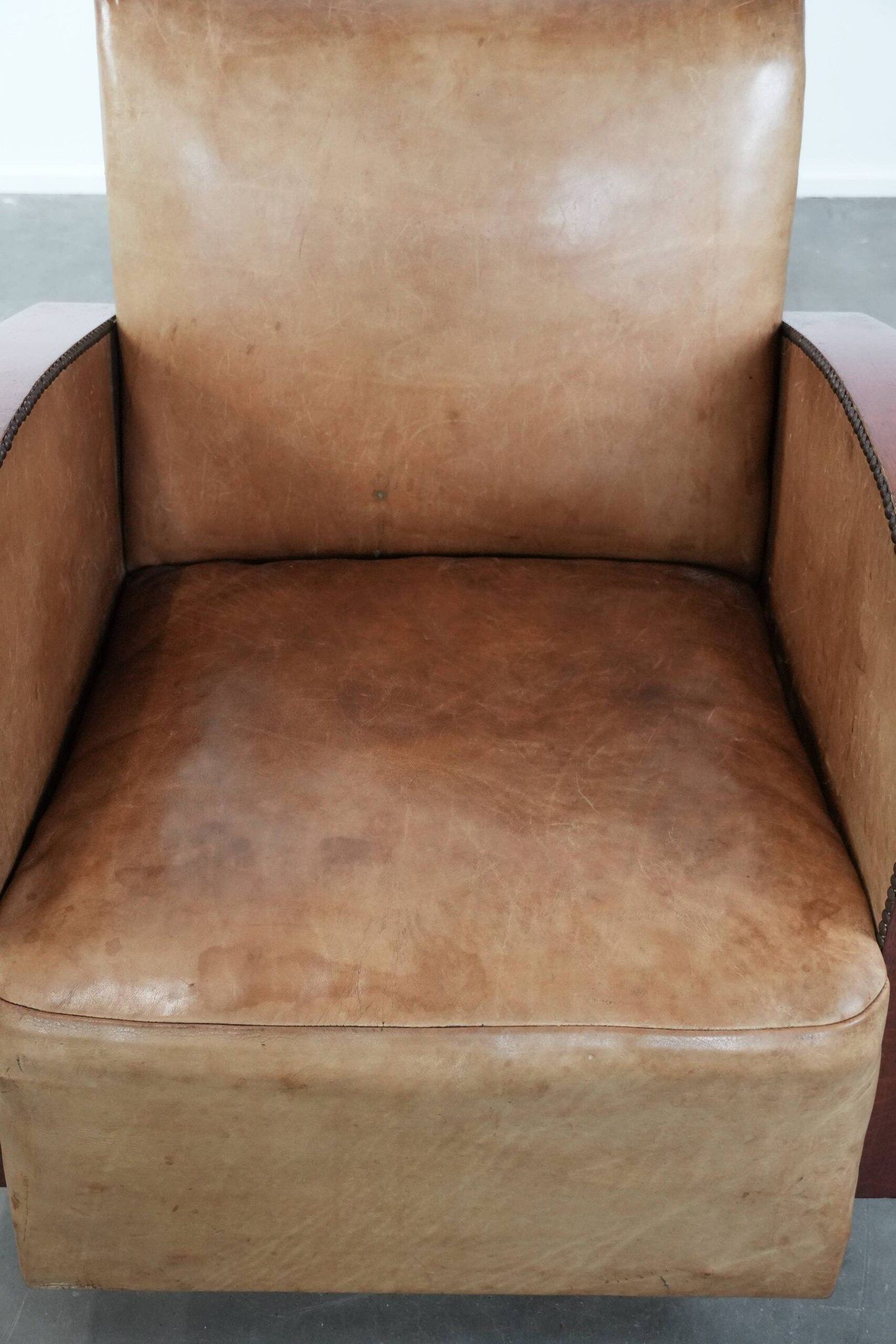 Art Deco design armchair in light cognac cowhide leather.