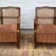 Pair of 1920s brown armchairs in carved wood and fabric, with caning detail.