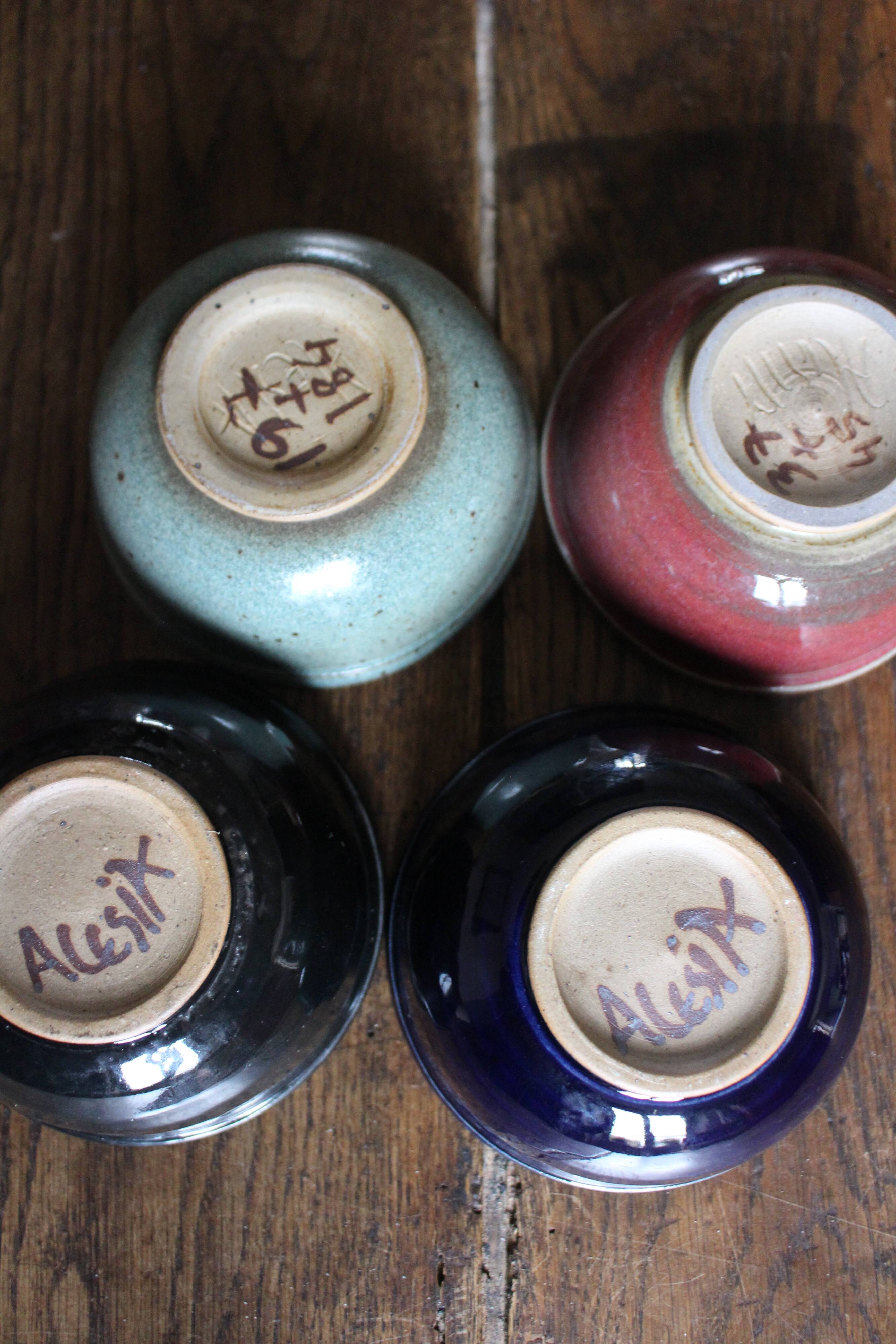A set of 4 pottery bowls in coloured glaze.