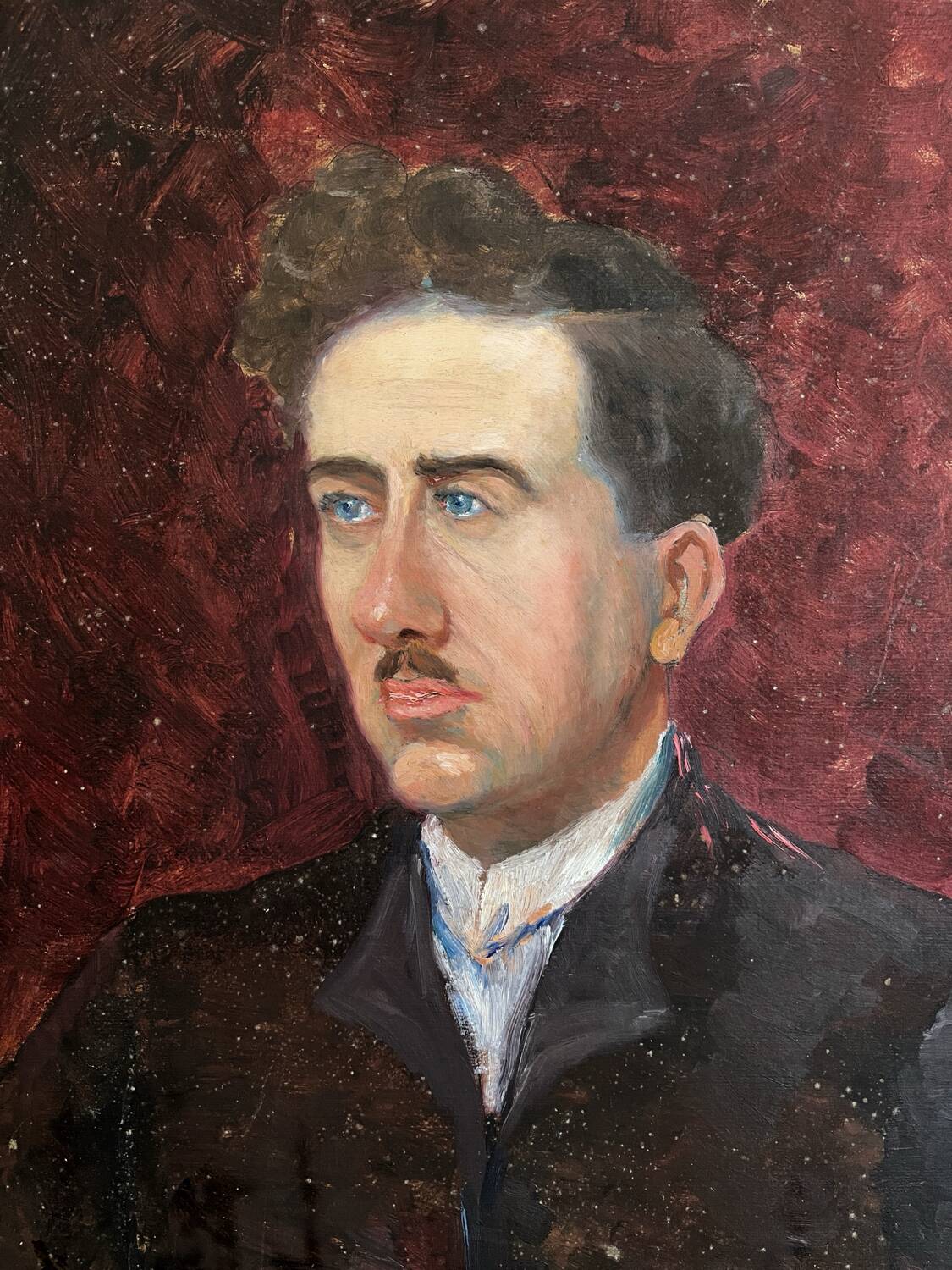 Old oil painting on cardboard portrait of a man in a dark suit
