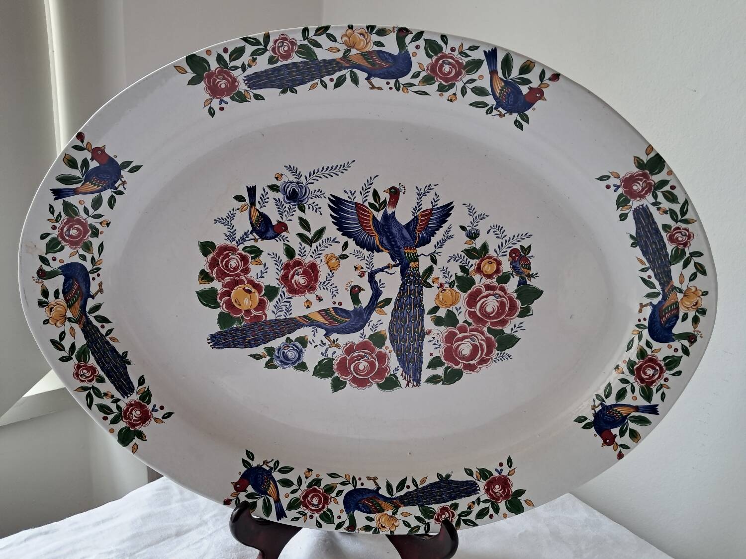 Large oval white ceramic platter, decorated with peacocks and vintage flowers