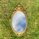 Old oval mirror in gilded resin - baroque style - 73 cm