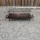 Vintage cast iron fireplace cradle with 16 bars.