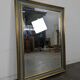 Rectangular mirror with a green and gold lacquered frame.
