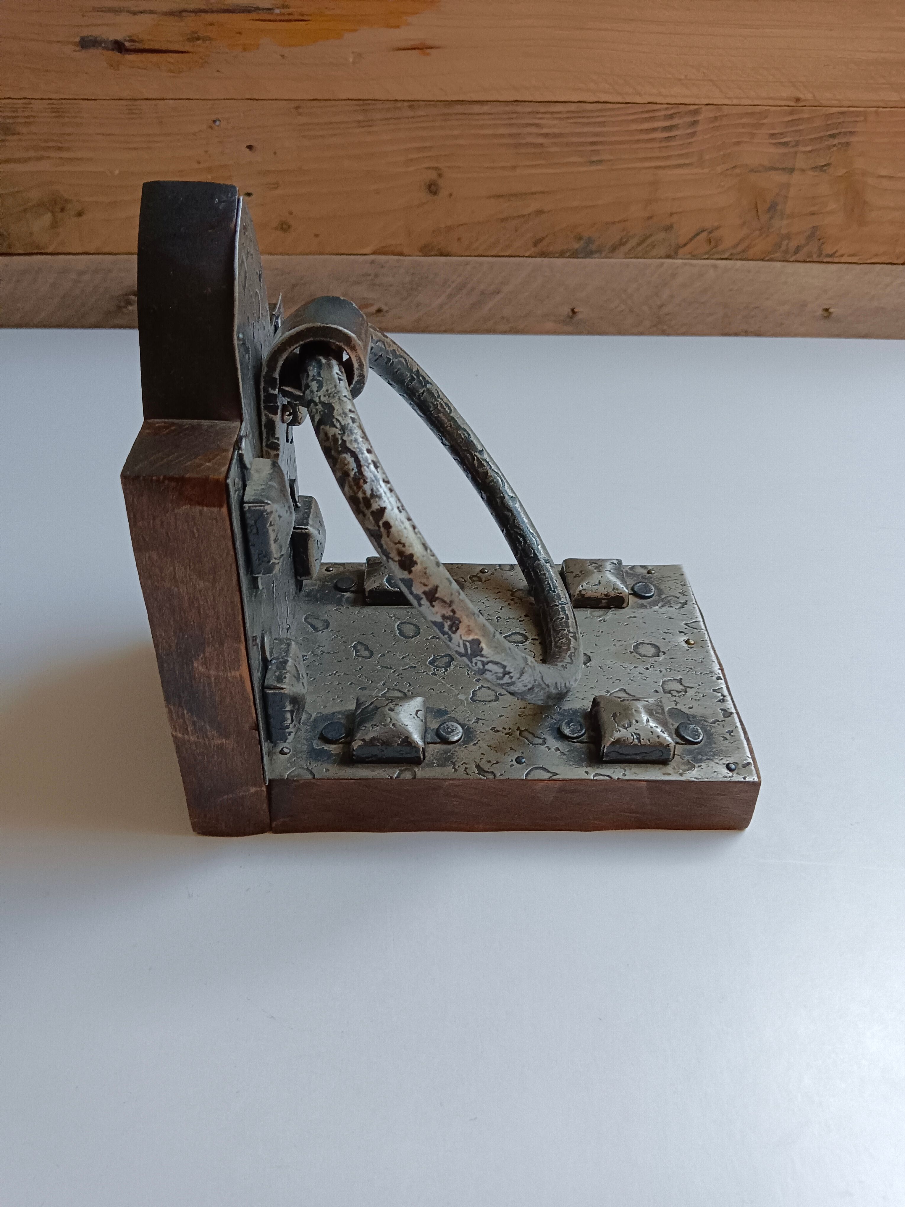 Medieval-style bookends, antique door handle.