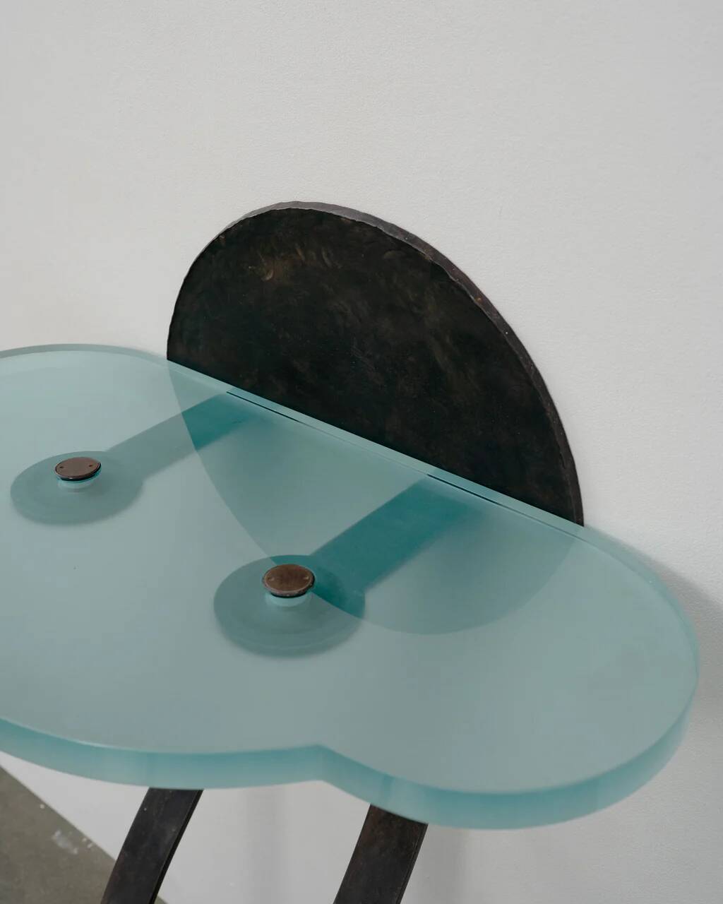 Artisanal wrought iron and cast glass leaning console table