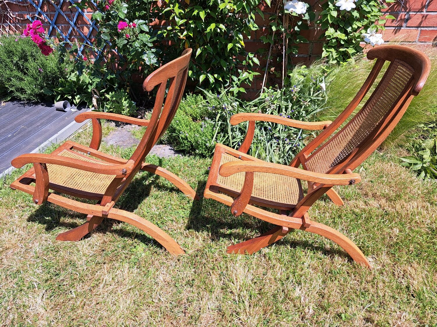 Pair of teak and cane deckchairs