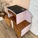 Art Deco bedside table in powder pink painted wood.