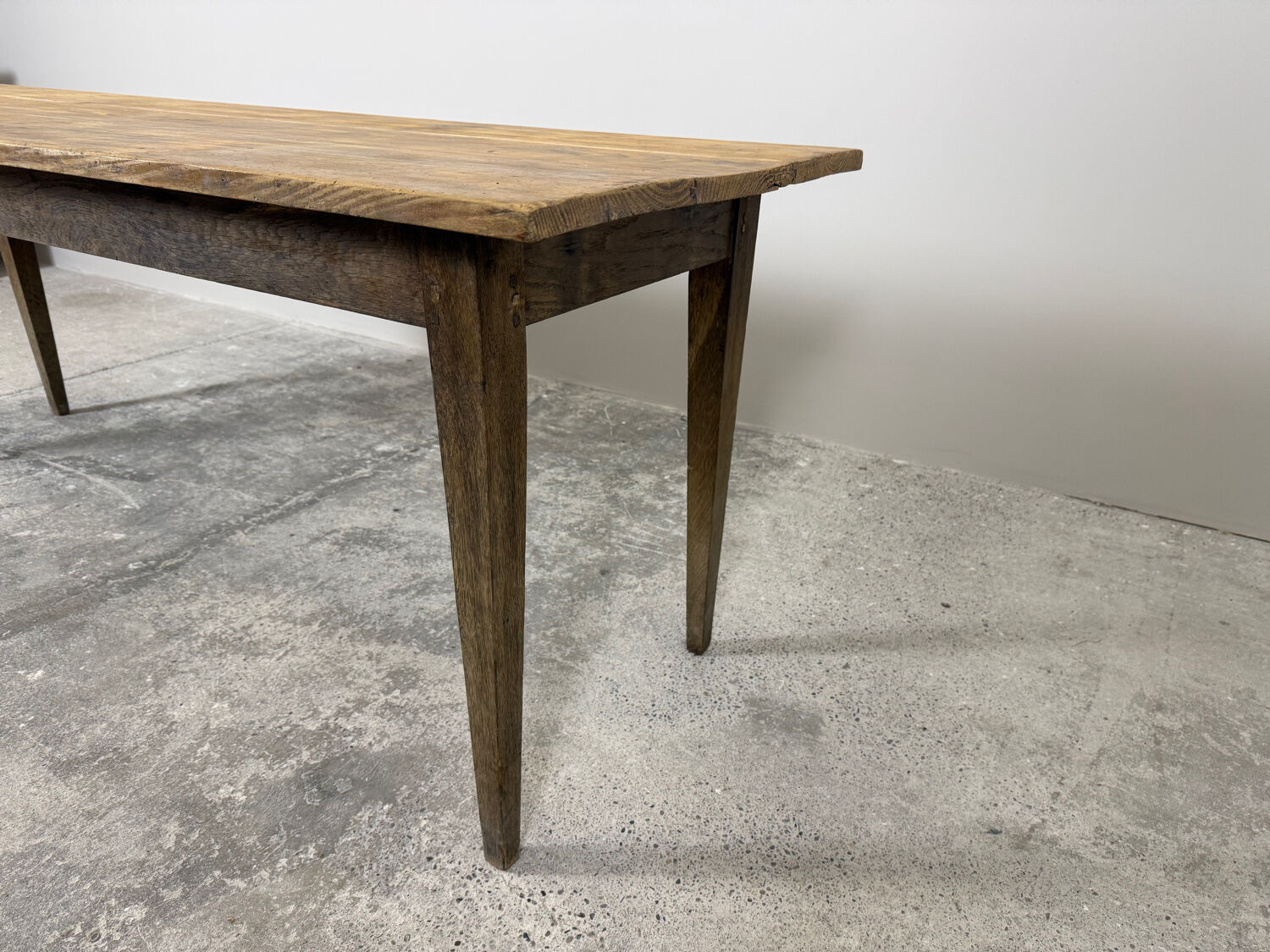 Old farmhouse table with tapered legs, late 19th to early 20th century.