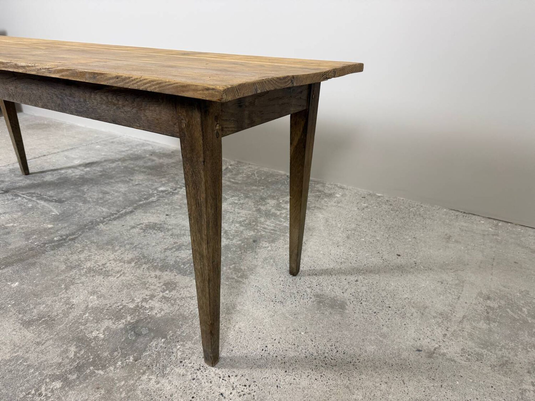 Old farmhouse table with tapered legs, late 19th to early 20th century.