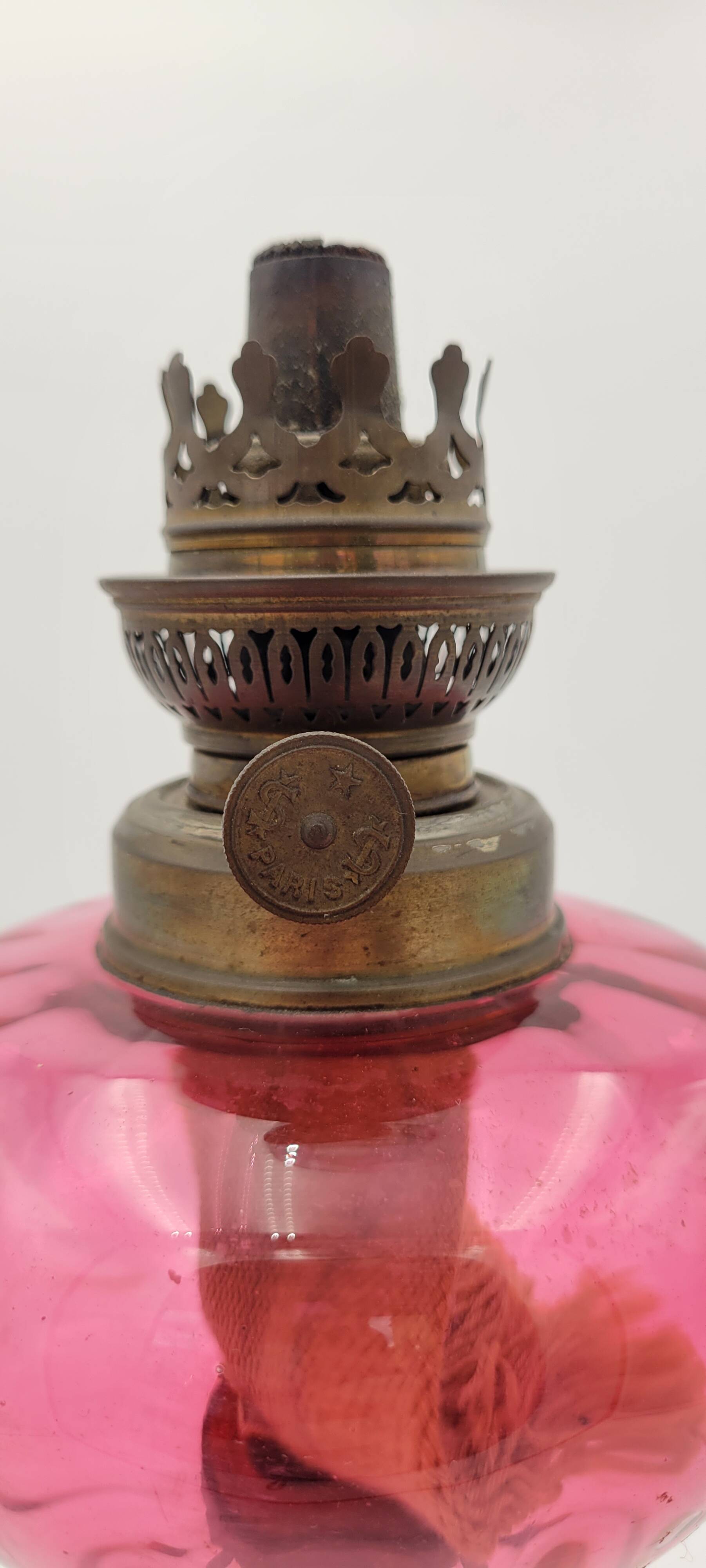 Old metal and pink glass oil lamp