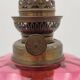 Old metal and pink glass oil lamp