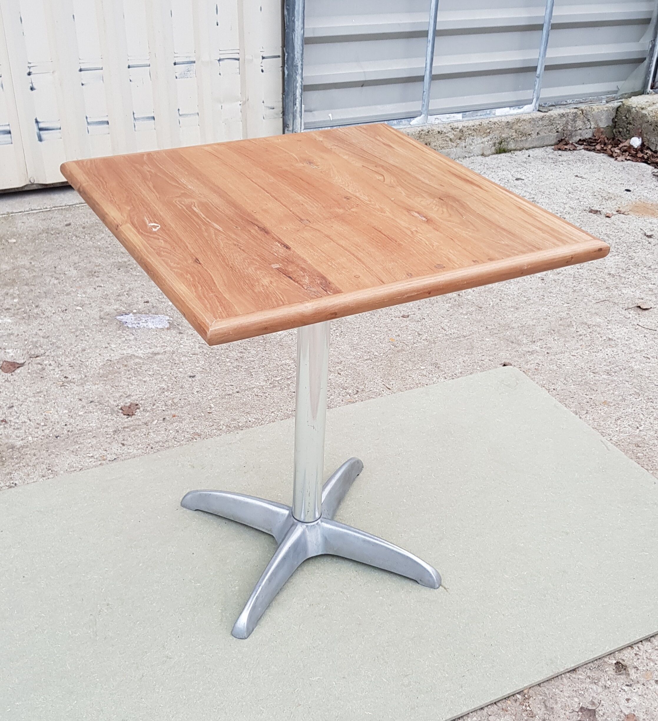 Foldable bistro table with teak top and aluminum base
