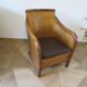 Colonial style armchair in woven rattan and exotic wood