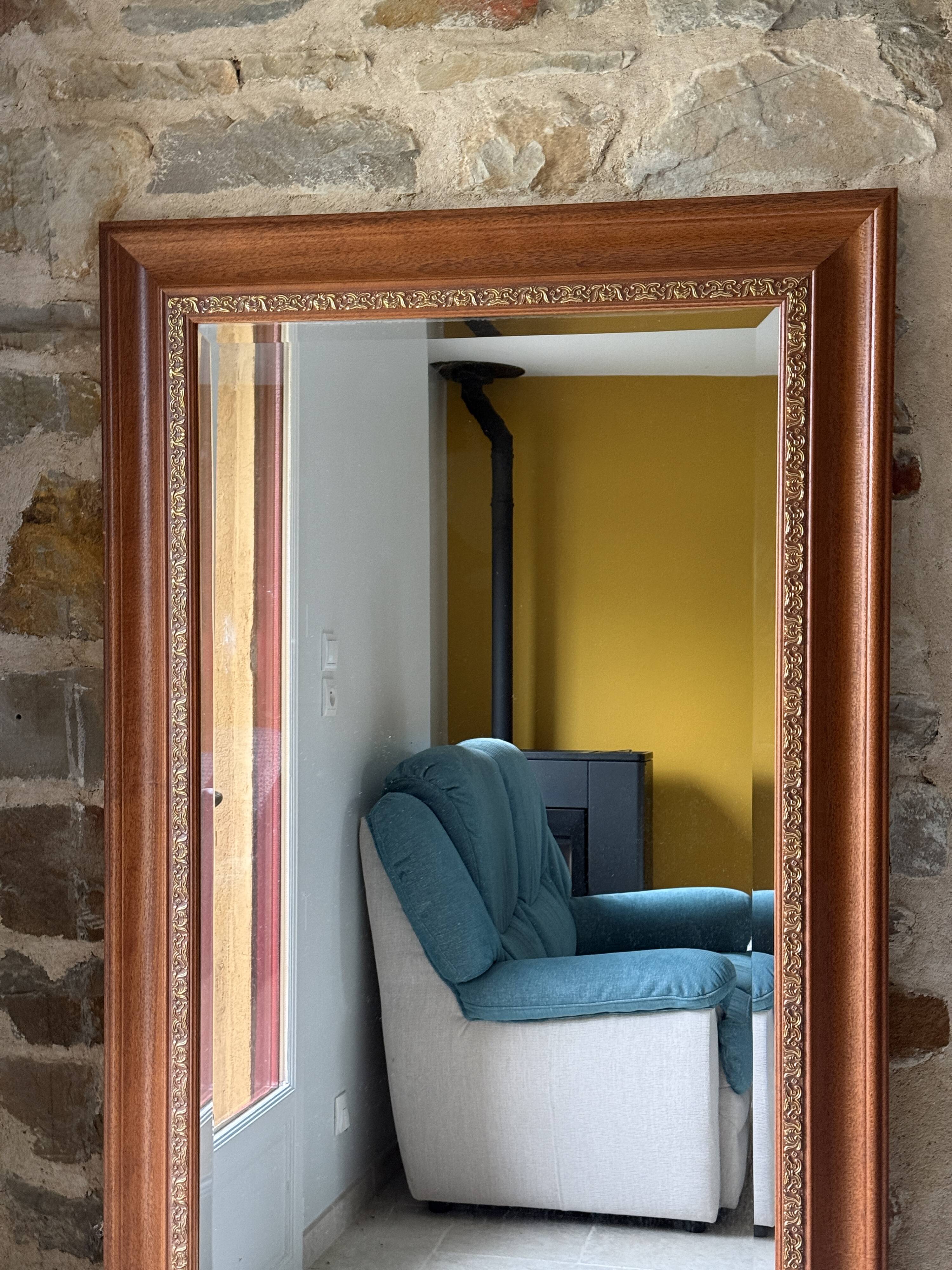 Large bevelled tabletop mirror in carved gilded wood.