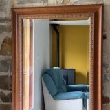 Large bevelled tabletop mirror in carved gilded wood.