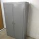 Curved wardrobe workshop locker made of wood repainted in grey.