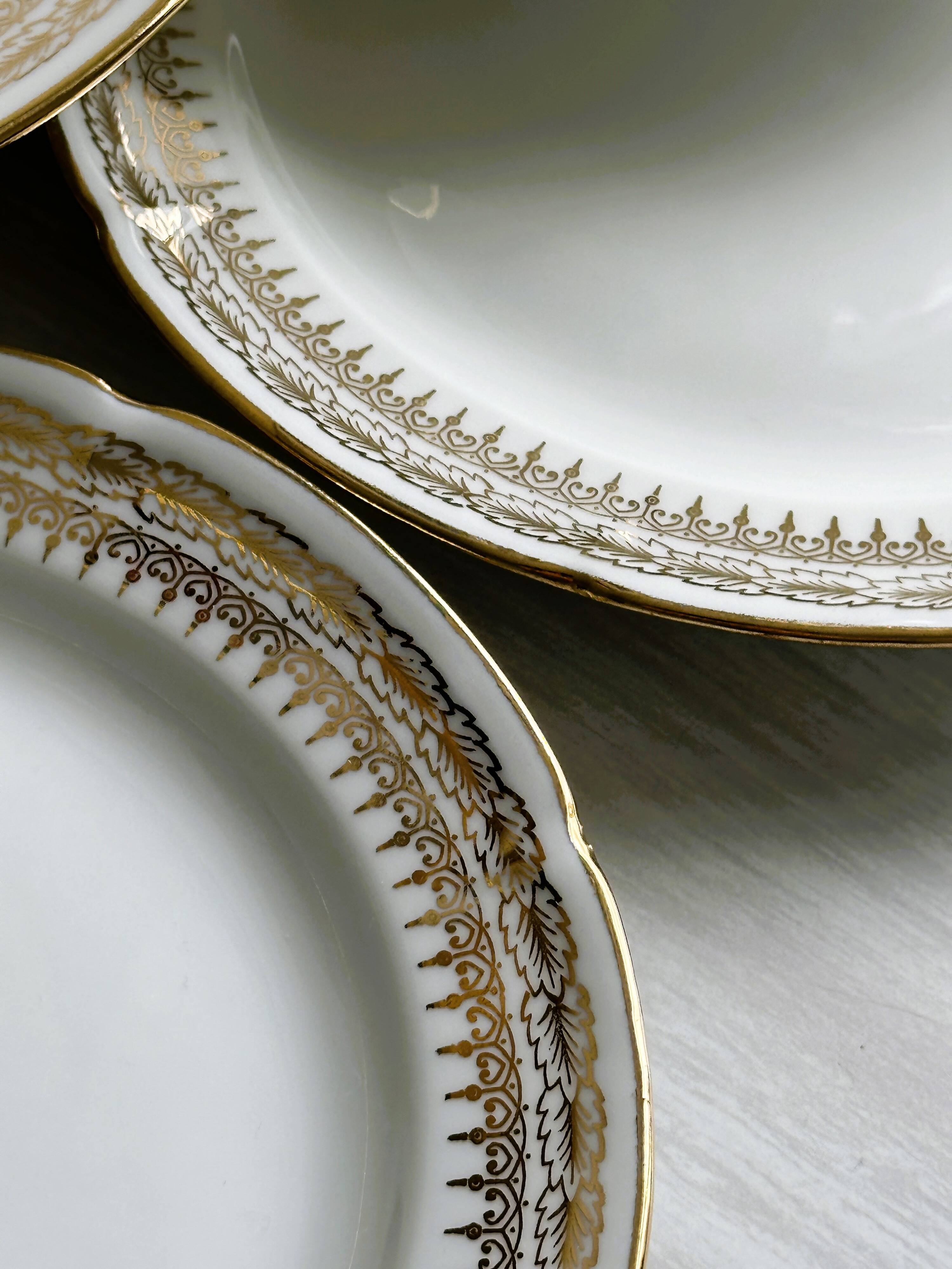 12 Limoges porcelain dessert plates, gold decoration.
