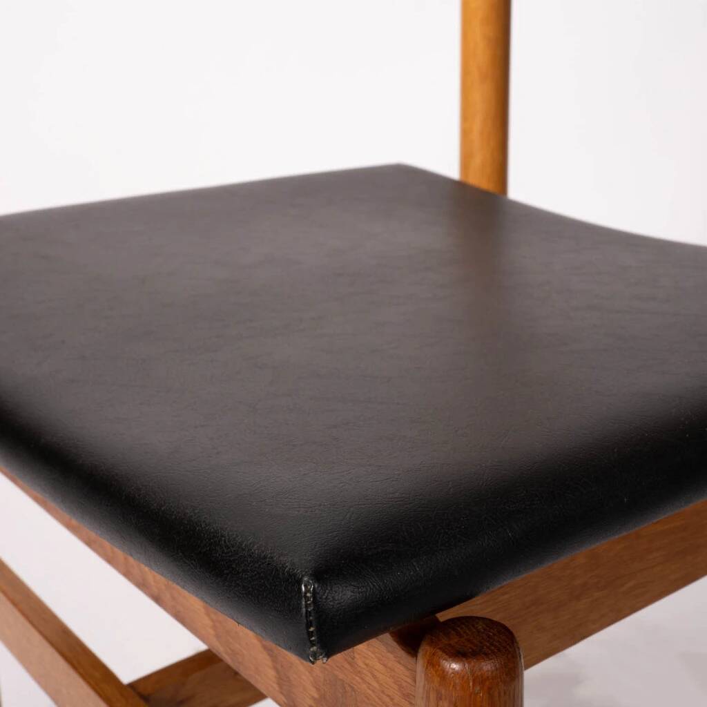Oak chair with a black leather seat made in the 1960s